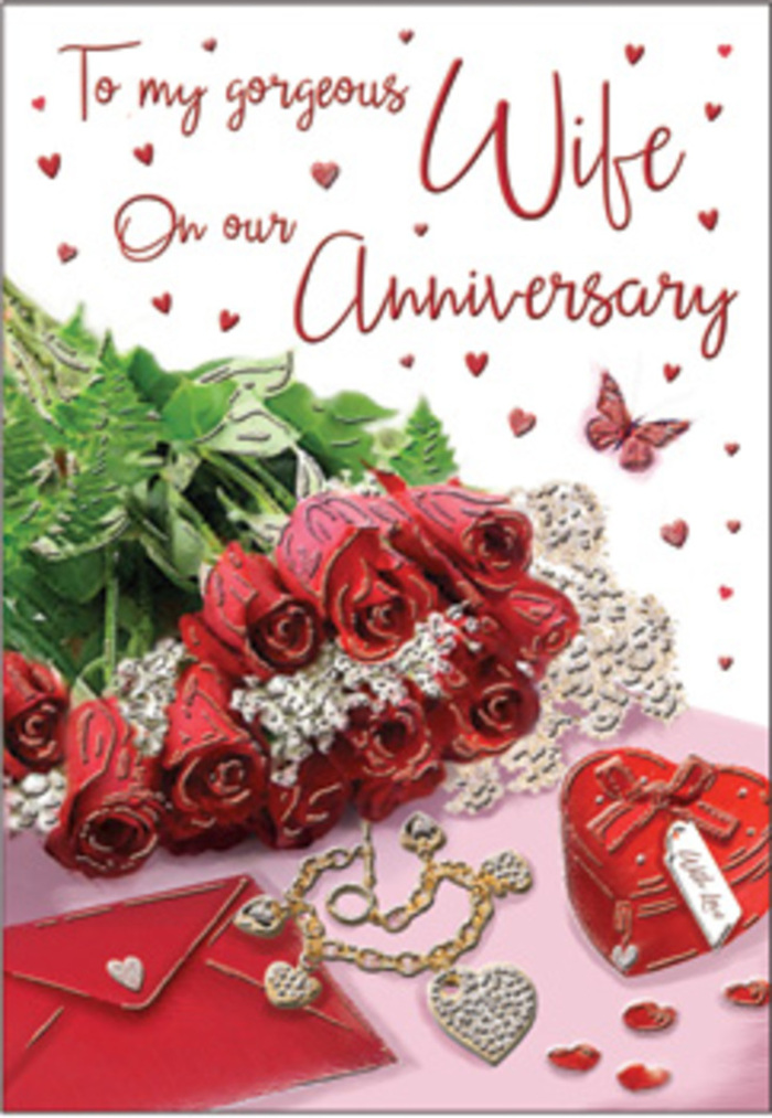This richly detailed anniversary card composition resembles a romantic still life you might stumble upon in a cosy Spitalfields apartment after an evening stroll through Brick Lane. At the centre, an indulgent cluster of classic red roses is arranged with deliberate care, each bloom fully open and velvety, their deep crimson petals folding outward in lush spirals. The roses are nestled amidst glossy green foliage, the leaves overlapping and lifting the flowers to create a sense of fullness and movement, much like bouquets crafted in the studios around Spitalfields Market. Close by, an envelope and matching greeting card lie partially atop one another, their soft cream surface and flowing calligraphy adding refinement and tenderness. Scattered delicately around this duo are personal, romantic treasures: a heart-shaped jewellery box in a bold red shade, a fine necklace composed of linked hearts, and perhaps subtle earrings or a bracelet set with small stones that twinkle in the light. Tiny hearts, some sparkling, others gently matte, drift across the background as if scattered by hand, suggesting the joyful chaos of celebration. A single butterfly motif, poised near the roses, introduces a light, almost whimsical note that contrasts beautifully with the rich reds and golds. The lighting is soft and caressing, like late afternoon sun filtering through old brick and glass, gently illuminating every curve of petal and every glint of metal. Together, these elements convey a sense of intimacy and continuity-a visual love note that feels at home in Spitalfields, blending classic romance with the creative soul of East London and offering a perfect backdrop for honouring years of shared memories.